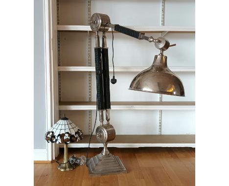 A modern floor standing anglepoise lamp, nickel plated, raised on a stepped base, together with a Tiffany style table lamp. (