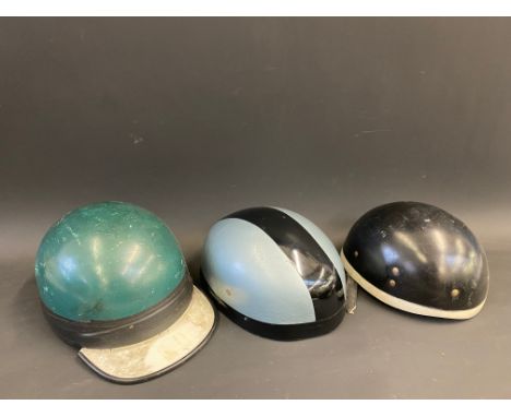 Two Centurian Victor pudding basin motorcycle helmets and one other with a peak.