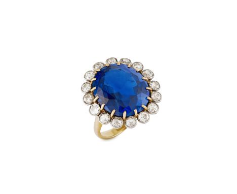 SAPPHIRE AND DIAMOND CLUSTER RINGThe oval-cut sapphire weighing 14.97 carats within an old brilliant and cushion-shaped diamo