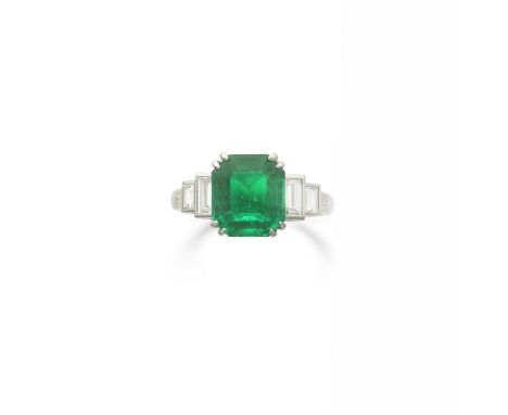 EMERALD AND DIAMOND RINGThe step-cut emerald, weighing 3.35 carats, between baguette-cut diamond shoulders, ring size MFootno