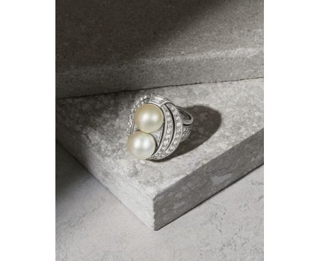 NATURAL PEARL AND DIAMOND RING, CIRCA 1935The 9.4mm-10.1mm natural pearls, within a pierced and sculptural surround of brilli