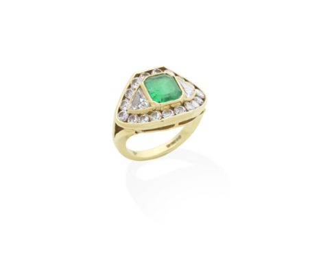 KUTCHINSKY: EMERALD AND DIAMOND RING, 1988The step-cut emerald within a brilliant and trilliant-cut diamond surround, mounted