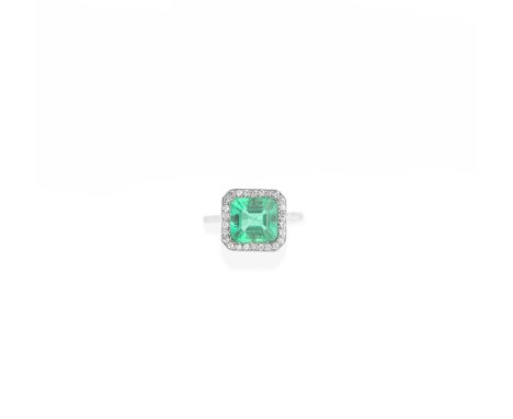 EMERALD AND DIAMOND RING, EARLY 20TH CENTURYThe step-cut emerald, within a single-cut diamond surround, mounted in platinum, 
