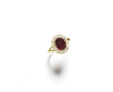 SPINEL AND DIAMOND RINGThe oval-cut red spinel, weighing 3.06 carats, within an old brilliant-cut and cushion-shaped diamond 