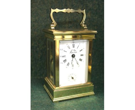 Small modern brass cased carriage clock with alarm function, the enamel dial with Arabic and Roman numerals, signed L' Epee, 