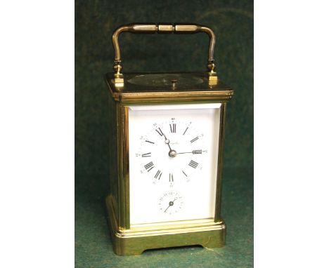 Brass cased carriage clock, the enamel dial with Arabic and Roman numerals, signed Angelus, the two train movement with hour 