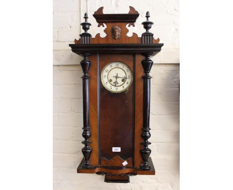 Late 19th Century Continental walnut and ebonised Vienna style wall clock, the enamel dial with Arabic numerals and two train