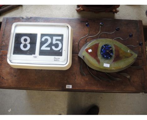 20th Century Grayson quartz flicker wall clock and a modern glass mounted quartz clock in the form of an eye 