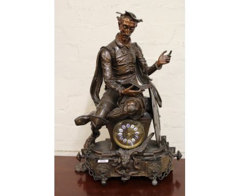 19th Century Continental patinated spelter mantel clock surmounted by a seated figure of Don Quixote, the circular dial with 