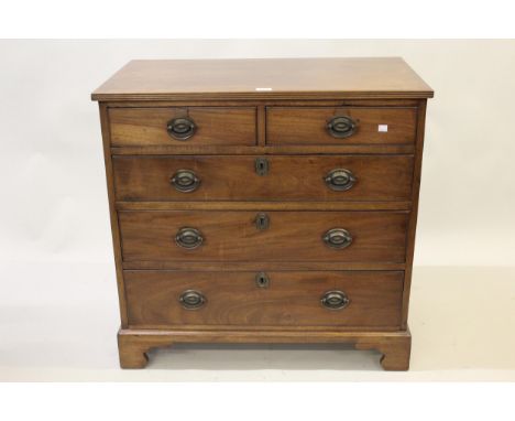 Small 19th Century mahogany straight front chest of two short and three long graduated drawers with oval brass handles and br
