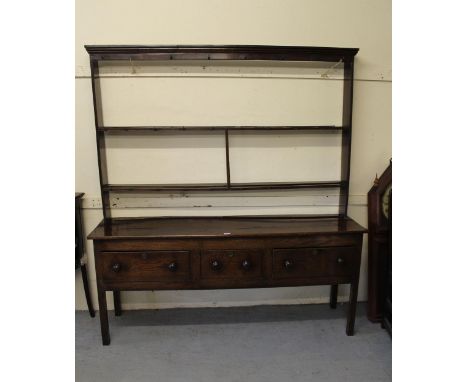 George III oak dresser, the open shelf back above an arrangement of drawers, 197cm high x 181cm wide x 47cm79cm high.Shelves 