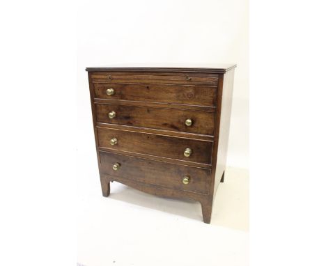 19th Century mahogany dwarf chest with a brushing slide above four graduated drawers with brass handles and bracket feet, 68c