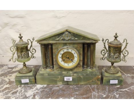 French green onyx gilt metal mounted clock garniture, the gilded and ceramic dial with Arabic numerals, with a two train move