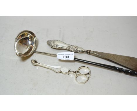 Pair of antique silver sugar nips together with an antique silver toddy ladle with whale bone handle and a silver handled sho