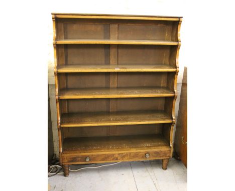 19th Century rosewood five shelf waterfall bookcase with single long drawer having brass knob handles on ring turned tapering