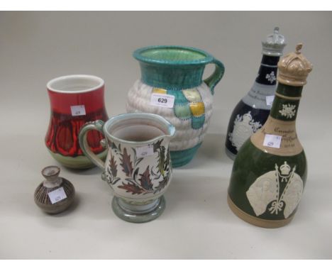 Crown Ducal jug decorated with a design after Charlotte Rhead, together with a pair of Copeland Spode decanters, Poole potter