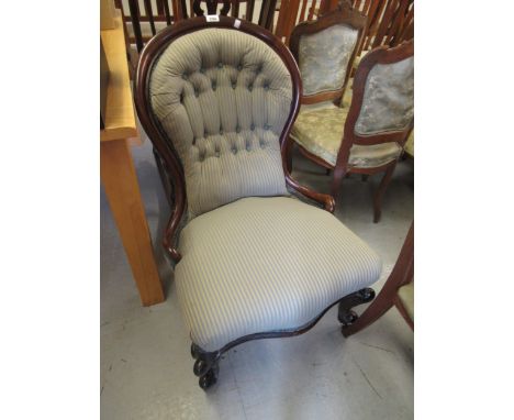 Victorian mahogany and button upholstered low seat nursing chair covered in a blue stripe fabric, on cabriole front supports 