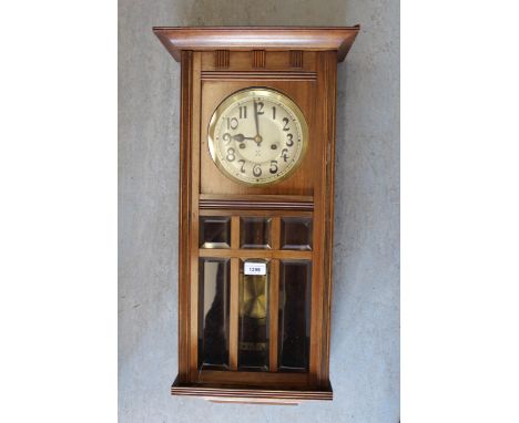 Early 20th Century Continental walnut rectangular wall clock, the silvered dial with Arabic numerals and two train movement a