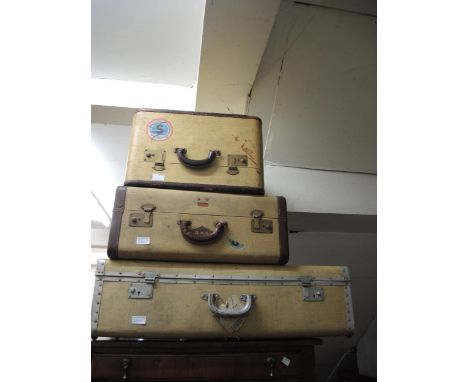 Three vintage suitcases with various shipping labels, together with a leather briefcase 
