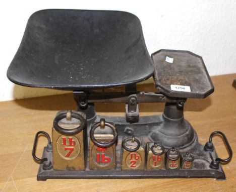 Pair of Victorian cast iron kitchen scales with graduated set of weights, together with a similar pair and another pair of an