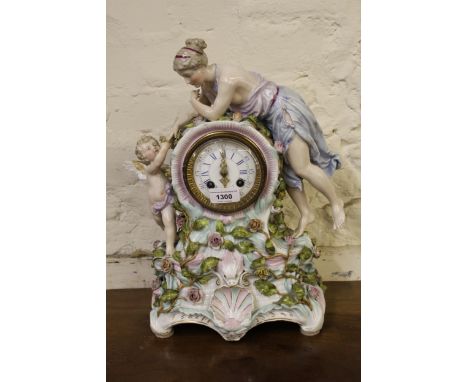 Large 19th Century Continental porcelain mantel clock with a female figure surmount, the enamel dial with Roman numerals and 