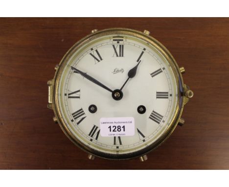 Ship's brass bulkhead clock, the painted dial with Roman numerals signed Schatz, with a two train movement, 18cm diameter 