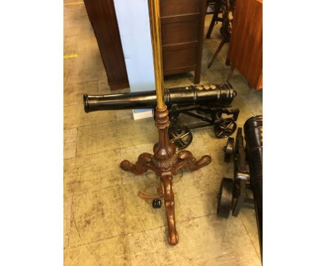 A brass and oak standard lamp