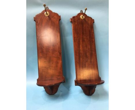 A pair of 19th century mahogany wall brackets, each with a small shelf above a brass hook, 70cm height