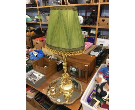 Gilt framed mirror and a lamp