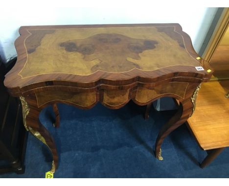 A reproduction walnut fold over games and card table with gilt metal mounts, 82cm wide