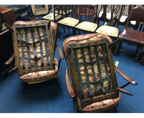 Pair of Ercol armchairs and a pair of Ercol footstools (frames only)