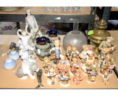 Collection of thirteen Goebel porcelain figures of children, together with a figure of a boy playing a mandolin, an Indian mo