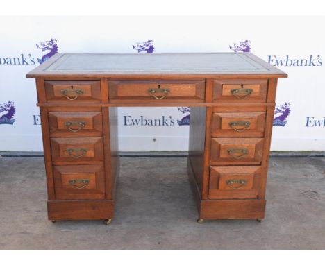 Early 20th Century mahogany kneehole desk, green and tooled leather top, above three frieze drawers, two pedestals with three