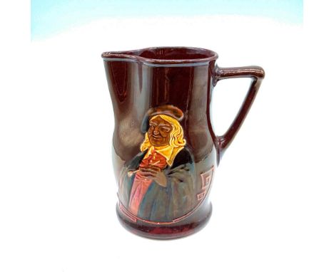 Jug with dark rich brown glaze and relief of Hogarth holding a pipe with artist's signature. Inscribed It is hard for an empt