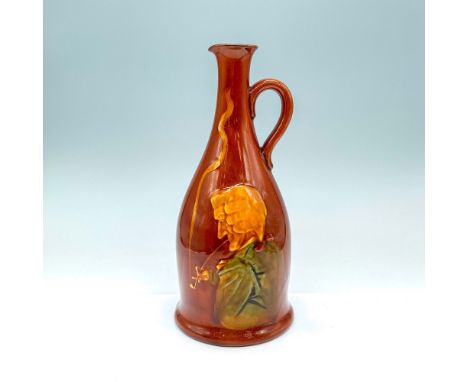 Glazed brown bottle pitcher with painted relief of a gentleman smoking a churchwarden pipe. Dewar's Scotch Whisky is printed 