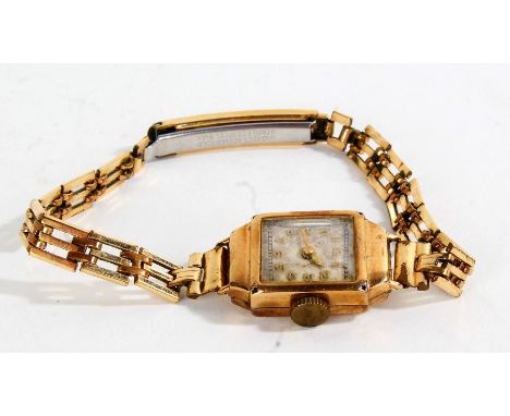 9 carat gold ladies wristwatch, the white dial with Arabic numerals, manual wound, the case 14mm wide, on a rolled gold brace