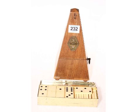 Woodbine cigarette tin of dominoes, together with a metronome (2).