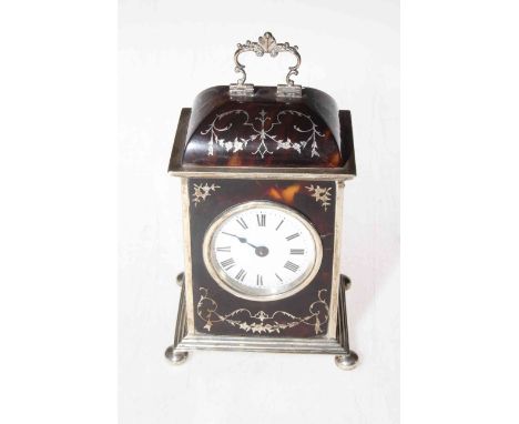 Silver and tortoiseshell boudoir mantel clock, having silver inlay decorations to tortoiseshell, ornate handle and on bun fee
