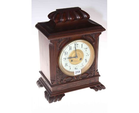 Carved walnut mantel clock with French movement by Maple &amp; Co. Ltd Paris, 36cm.