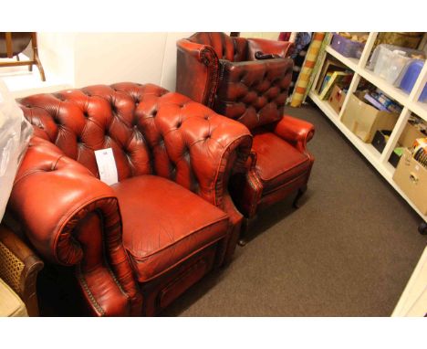 Red leather button backed Chesterfield armchair, wing back chair and footstool.