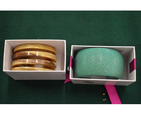 A Cuckoo Moment horn bangle and faux chagreen bangle.