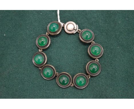 A silver and cabochon jade bracelet.