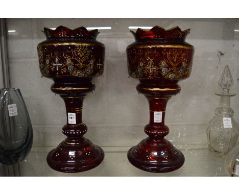 A pair of Victorian ruby glass gilt decorated and enamelled lustre bodies.