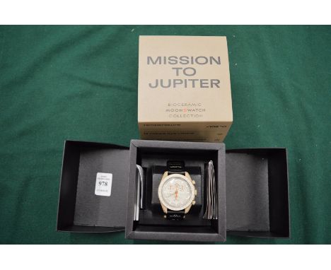 An Omega Swatch Mission to Jupiter wristwatch with original box and papers.