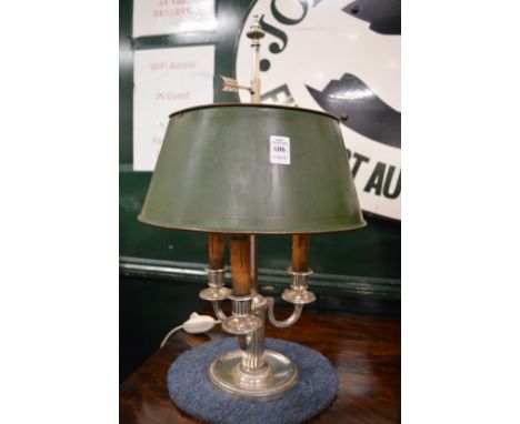 A silver plated three branch table lamp with green toleware shade.