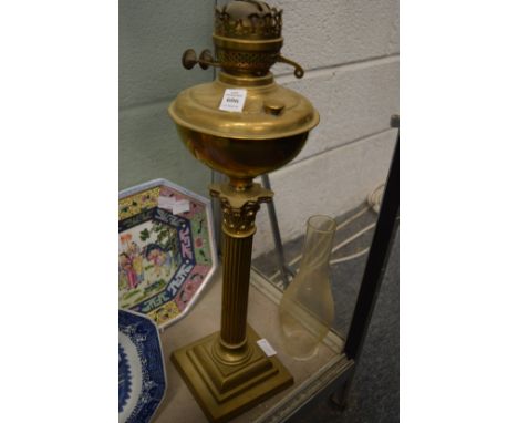 A brass corinthian column oil lamp.