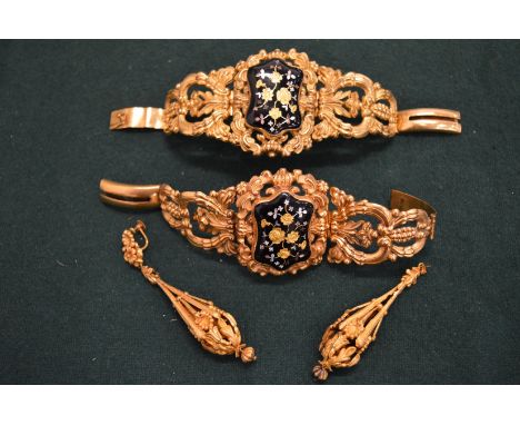 A pair of decorative yellow metal and enamel bracelets and a pair of yellow metal filigree chandelier earrings.