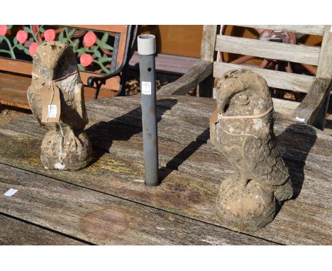 A pair of reconstituted stone gate post finials modelled as eagles.