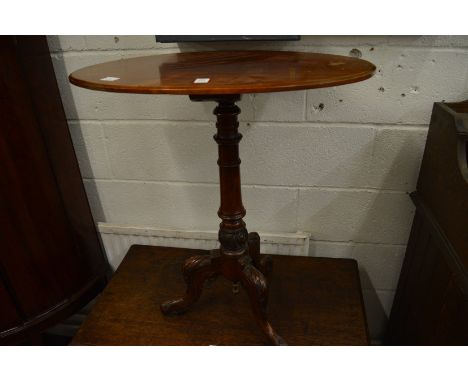 A Victorian mahogany oval tripod table.