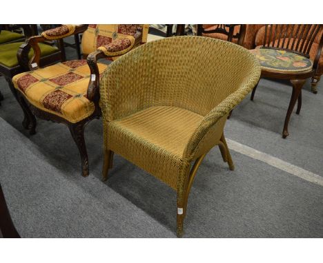 A lloyd loom armchair.